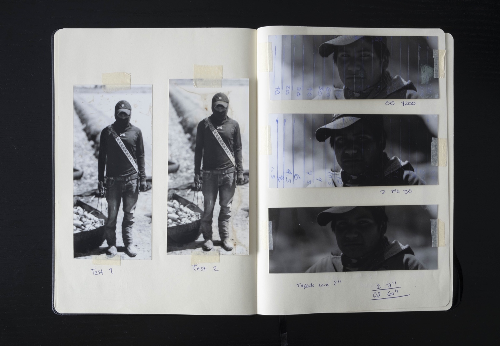 Black-and-white RA-4 exposure tests taped into a darkroom notebook